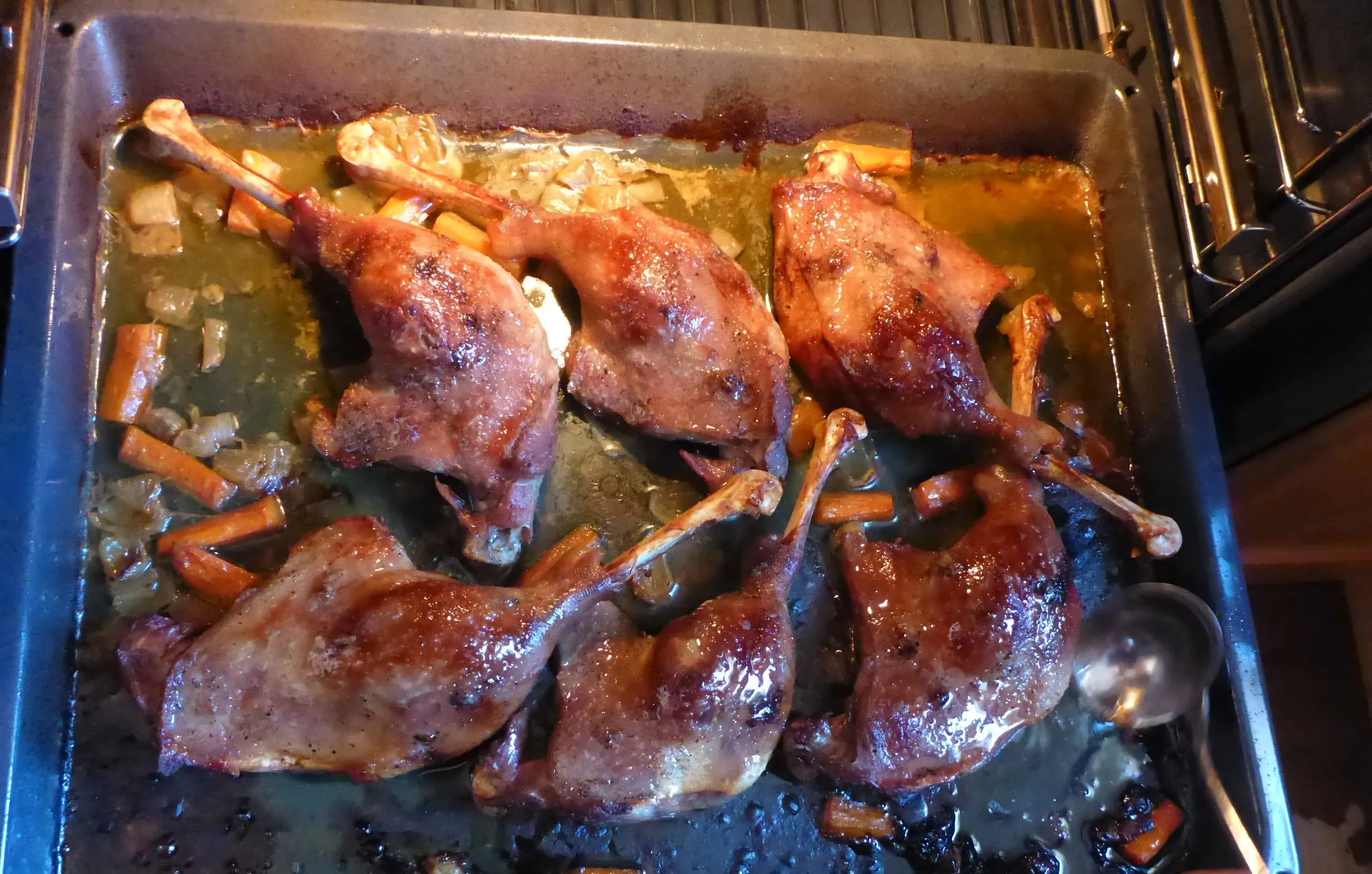 Goose legs undergoing the grilling process to achieve a wonderfully crispy skin.