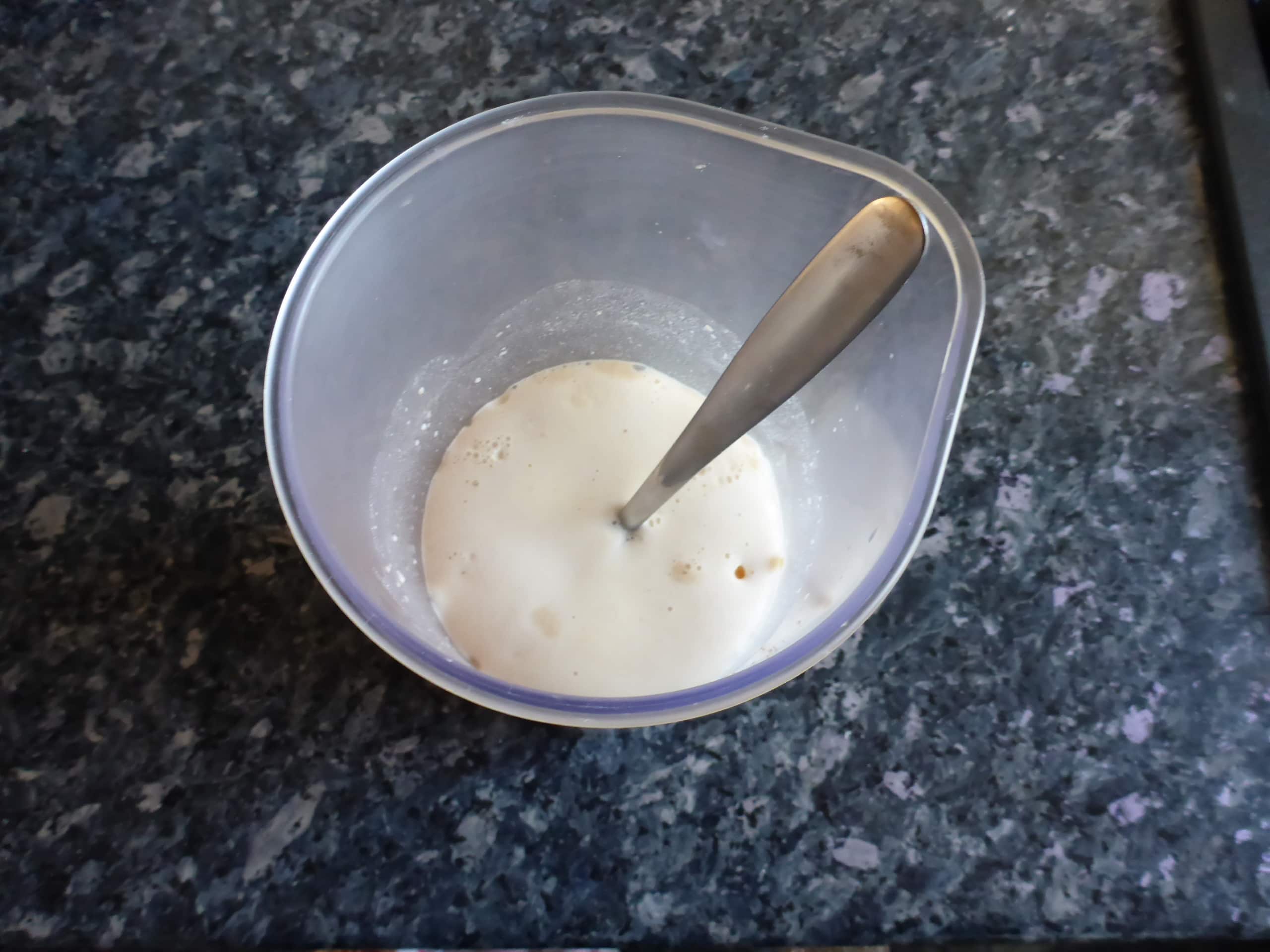 Activated Dry Yeast: Frothy Mixture of Bubbling Yeast Granules in Warm Water After 5 Minutes.