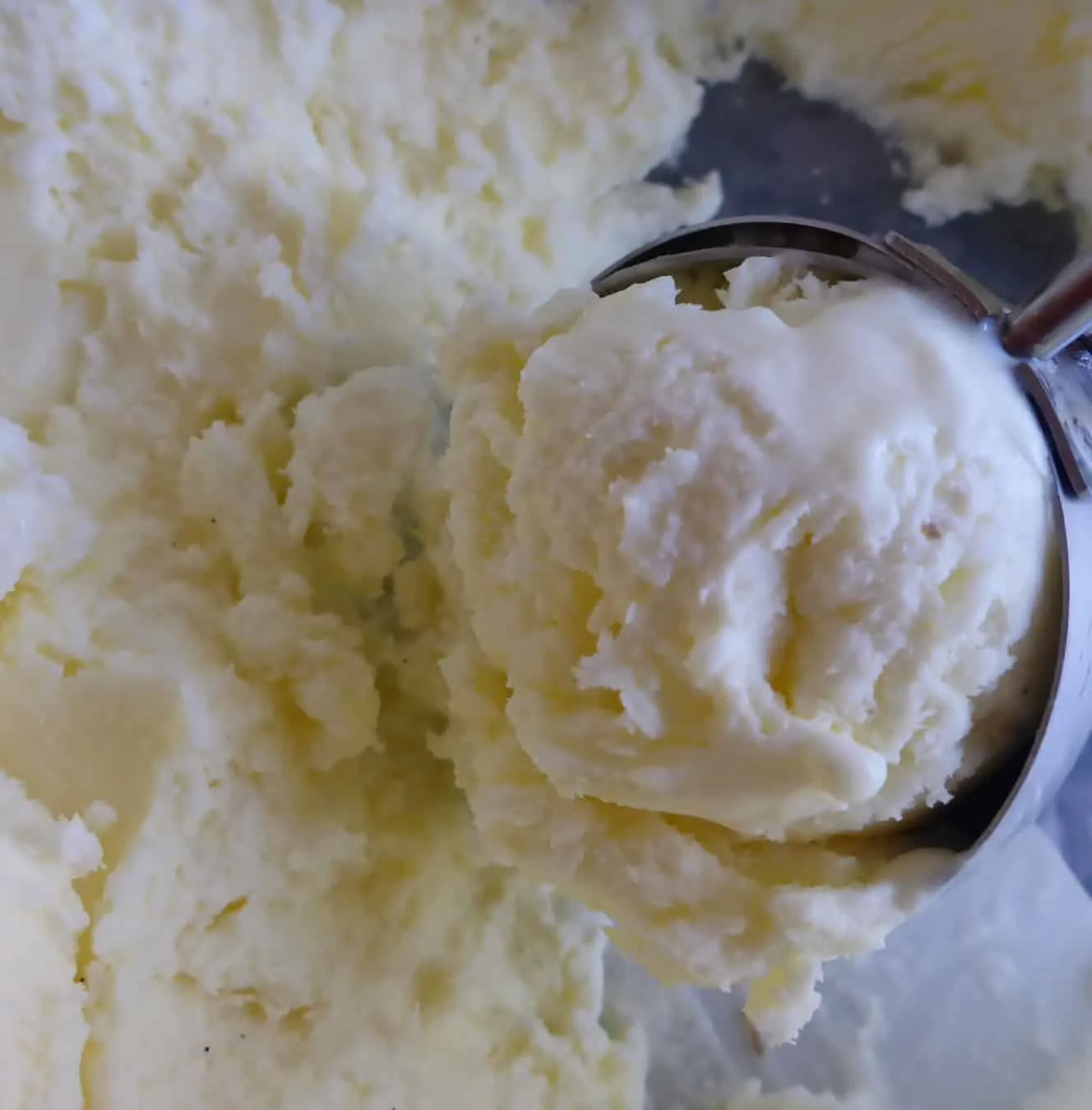 A box of homemade vanilla ice cream, perfectly chilled in the freezer and waiting to be enjoyed. Get your ice cream scoop ready for a delightful serving experience.