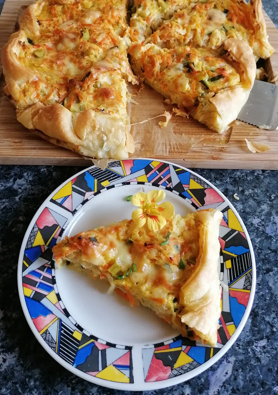 Freshly baked carrot kohlrabi quiche with puff pastry.