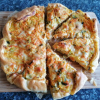 freshly baked kohlrabi puff quiche with carrots on the cutting board.