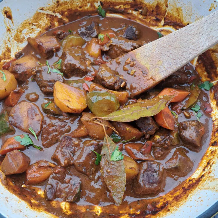 ich, freshly cooked South African beef stew with vegetables in a heavy-based pot, ready to be served.