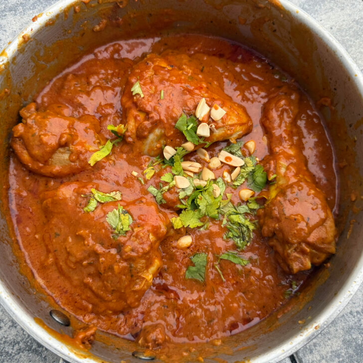 frisch gekochter afrikanischer H&auml;hnchen-Erdnusseintopf getoppt mit Erdn&uuml;sse und frischem Koriander