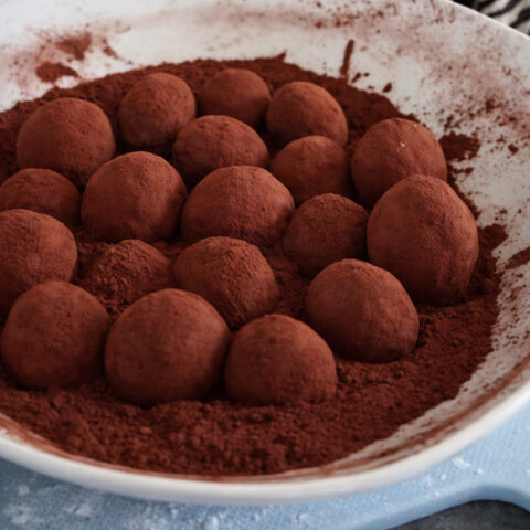 German marzipan potatoes (Marzipankartoffeln) tossed in unsweetened cocoa powder on a plate