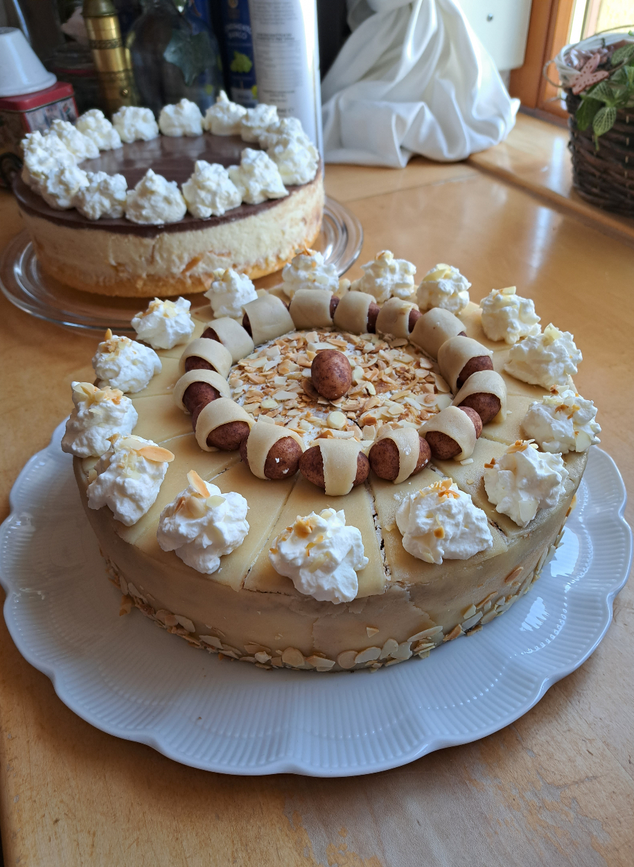 Homemade German poppy seed cake decorated with marzipan and almonds